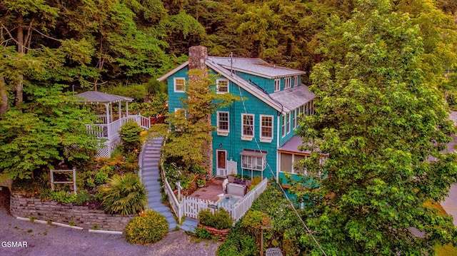 204 Hill St, Gatlinburg, TN 37738 - view of front of home featuring a chimney, stairs, and a wooded view