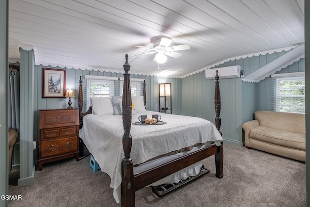 204 Hill St, Gatlinburg, TN 37738 - carpeted bedroom with a wall unit AC, multiple windows, a ceiling fan, and wood ceiling