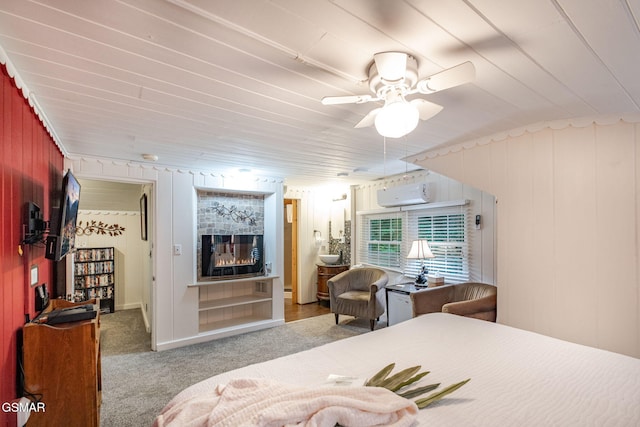 204 Hill St, Gatlinburg, TN 37738 - bedroom with a glass covered fireplace, carpet flooring, a wall mounted air conditioner, a ceiling fan, and wood walls