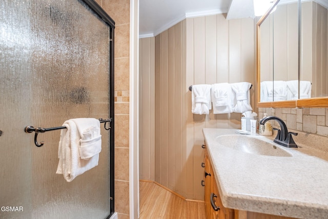204 Hill St, Gatlinburg, TN 37738 - bathroom with a shower stall, vanity, crown molding, wood finished floors, and decorative backsplash