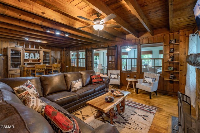204 Hill St, Gatlinburg, TN 37738 - living room with wood walls, ceiling fan, wood finished floors, and a wood ceiling with exposed beams