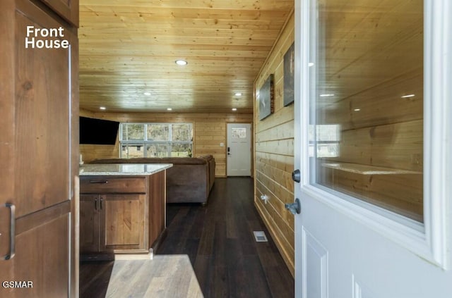 kitchen with dark wood-style floors, brown cabinets, recessed lighting, open floor plan, and wooden ceiling