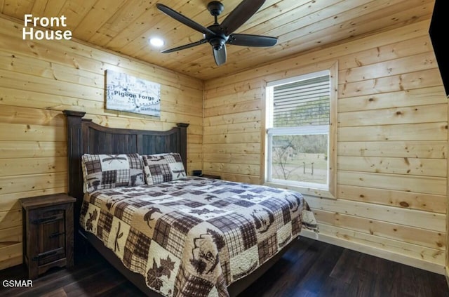 bedroom with dark wood-style flooring, wooden ceiling, and wooden walls