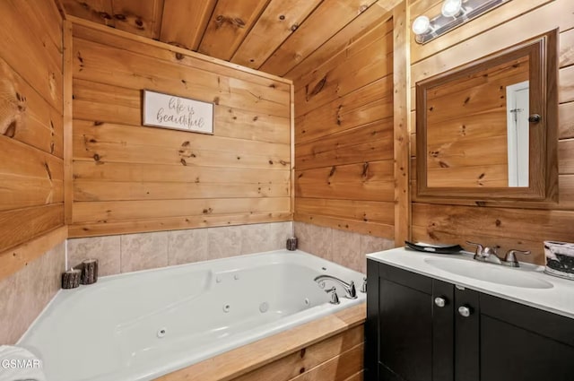 full bathroom featuring wood ceiling, wood walls, a jetted tub, and vanity