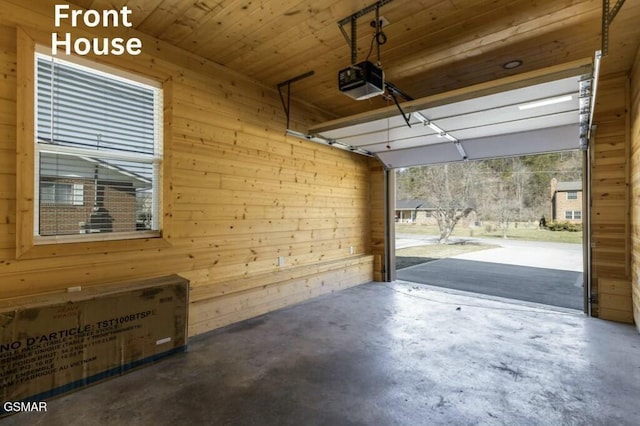 garage featuring wooden walls and a garage door opener