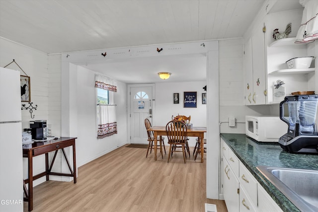 39693975 Wears Valley Rd, Sevierville, TN 37862 - kitchen with white appliances, dark countertops, light wood finished floors, open shelves, and white cabinets