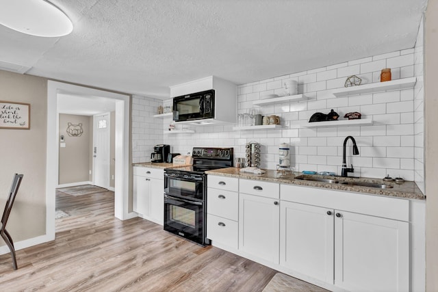 39693975 Wears Valley Rd, Sevierville, TN 37862 - kitchen featuring open shelves, black appliances, a sink, decorative backsplash, and light stone counters