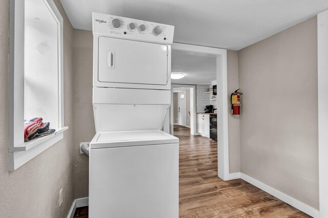 39693975 Wears Valley Rd, Sevierville, TN 37862 - washroom with stacked washer / dryer, wood finished floors, and baseboards