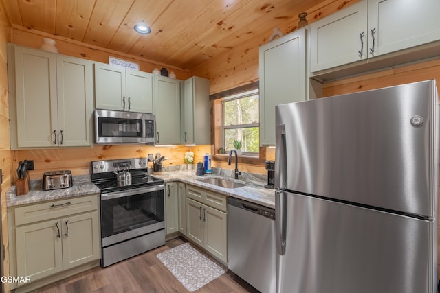 kitchen with sink, dark wood-type flooring, appliances with stainless steel finishes, light stone counters, and wooden ceiling