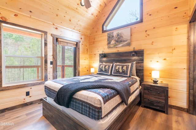 bedroom featuring wood-type flooring, lofted ceiling, wood ceiling, and wooden walls