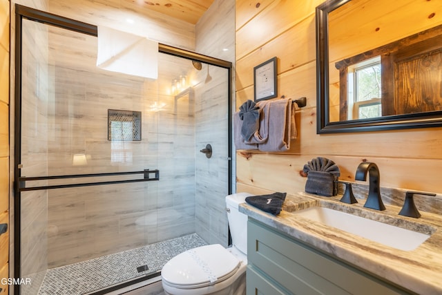 bathroom with toilet, vanity, an enclosed shower, and wooden walls