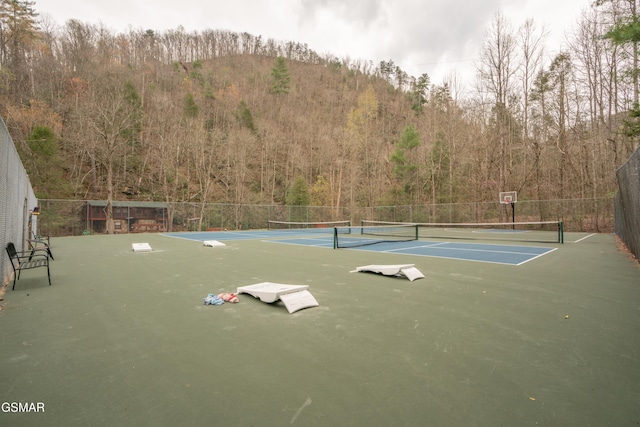 view of sport court with basketball hoop