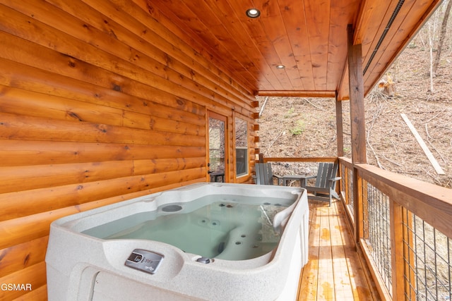 wooden terrace featuring a hot tub