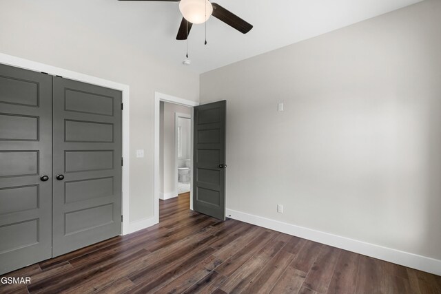270B W Main St, Dandridge, TN 37725 - unfurnished bedroom with dark wood-type flooring, baseboards, a closet, and a ceiling fan