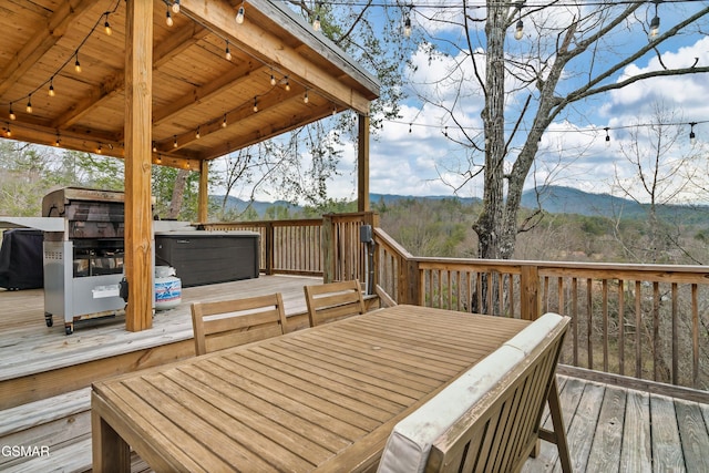 wooden terrace with a mountain view and a hot tub