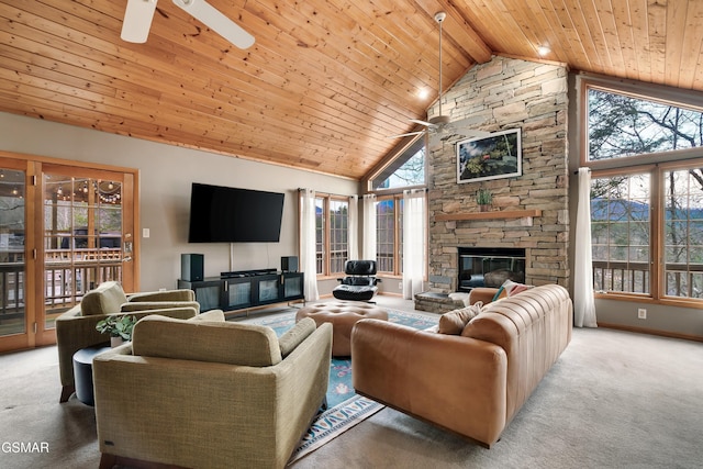 carpeted living area featuring wooden ceiling, a fireplace, a ceiling fan, and a healthy amount of sunlight