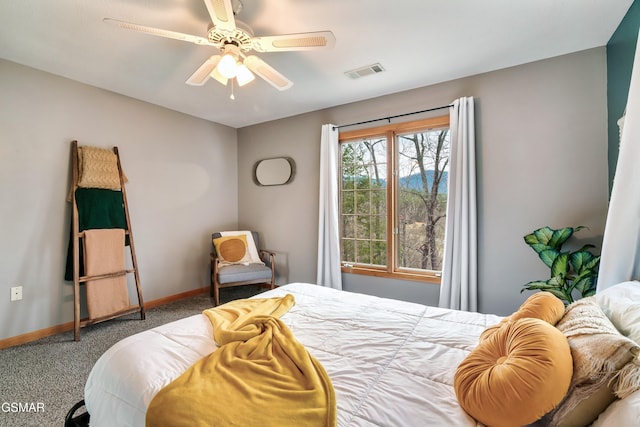 carpeted bedroom with a ceiling fan, visible vents, and baseboards