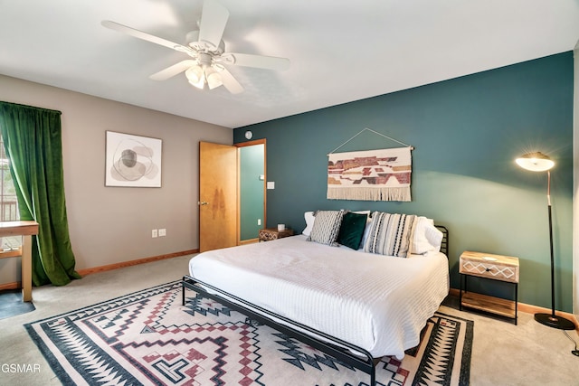 carpeted bedroom with ceiling fan and baseboards