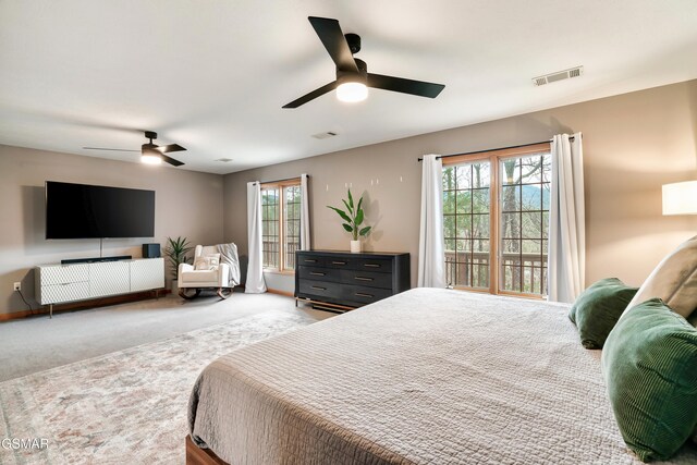 bedroom featuring multiple windows, carpet flooring, visible vents, and baseboards