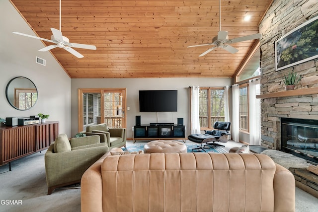 carpeted living area with high vaulted ceiling, a stone fireplace, wood ceiling, visible vents, and a ceiling fan