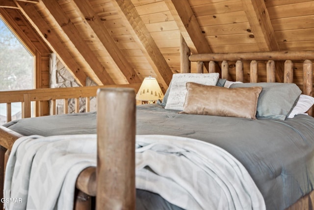 bedroom with lofted ceiling with beams and wooden ceiling