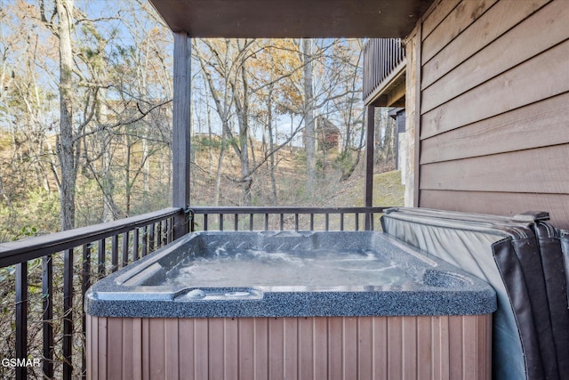 wooden deck with a hot tub