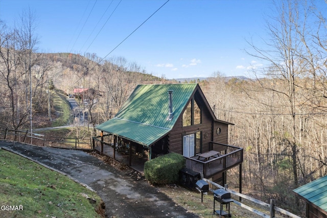 view of property exterior with a mountain view