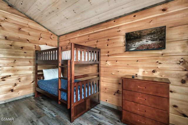 bedroom with vaulted ceiling, wooden ceiling, wooden walls, and wood finished floors