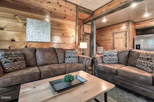 living area featuring beam ceiling, wood ceiling, visible vents, and wood walls