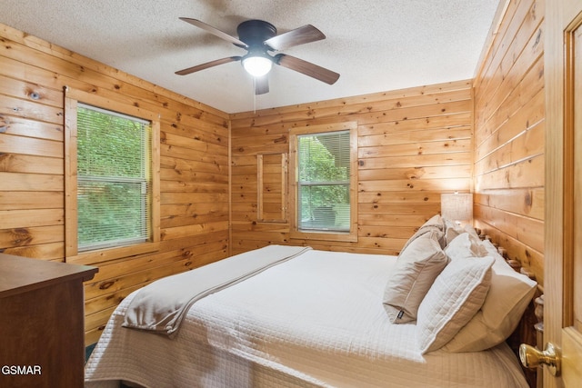 2112 Redmond Way, Sevierville, TN 37876 - bedroom with a textured ceiling, wooden walls, and a ceiling fan