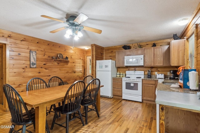2112 Redmond Way, Sevierville, TN 37876 - kitchen featuring white appliances, a ceiling fan, wooden walls, a textured ceiling, and light wood-style flooring