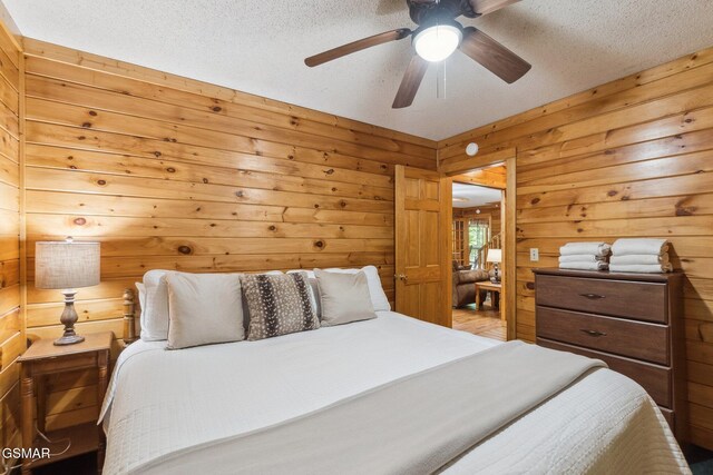2112 Redmond Way, Sevierville, TN 37876 - bedroom with wood walls, a textured ceiling, and ceiling fan