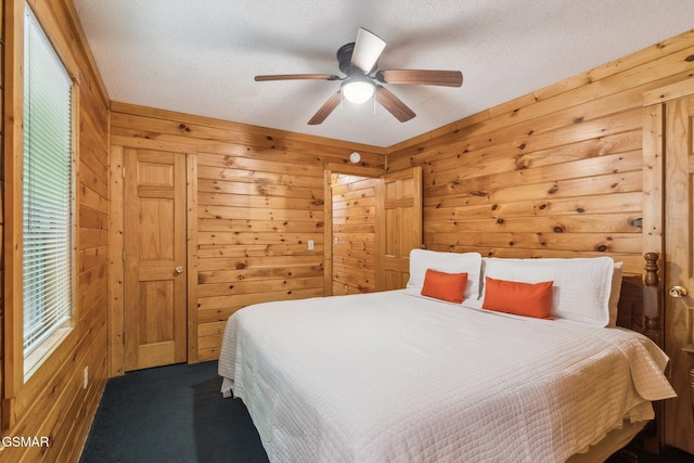 2112 Redmond Way, Sevierville, TN 37876 - bedroom featuring wood walls, carpet, a textured ceiling, and a ceiling fan