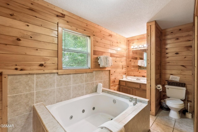 2112 Redmond Way, Sevierville, TN 37876 - bathroom with toilet, a tub with jets, a textured ceiling, tile patterned floors, and vanity