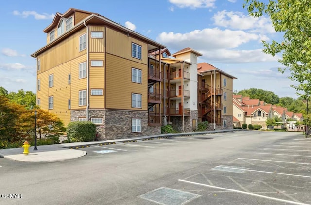 view of building exterior featuring uncovered parking