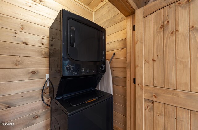 2741 Red Sky Dr, Sevierville, TN 37862 - laundry room with stacked washer and clothes dryer and wooden walls