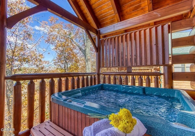 wooden deck with a hot tub