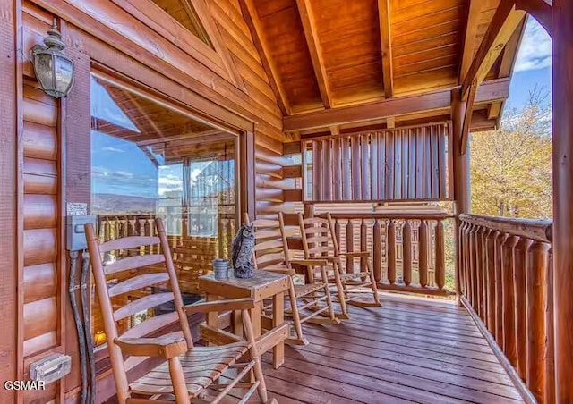 sunroom featuring vaulted ceiling with beams, wooden ceiling, and a healthy amount of sunlight