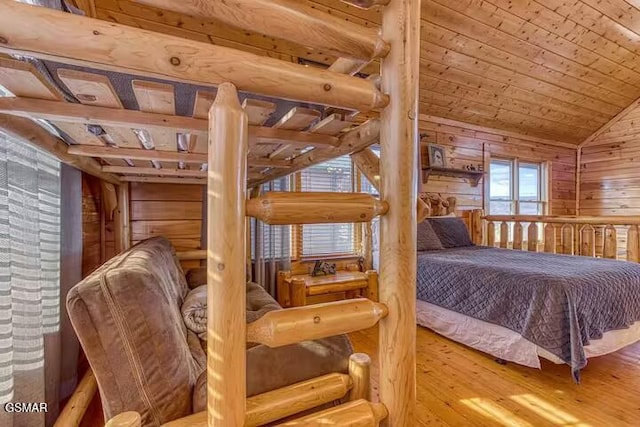 bedroom featuring hardwood / wood-style floors, wood ceiling, lofted ceiling, and wood walls