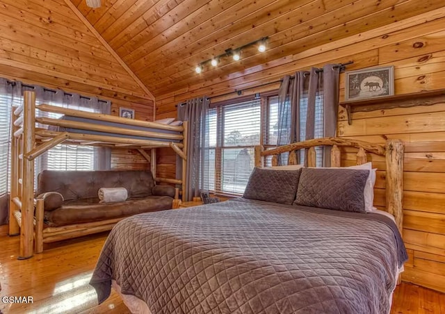 bedroom featuring hardwood / wood-style flooring, vaulted ceiling, wood ceiling, and multiple windows