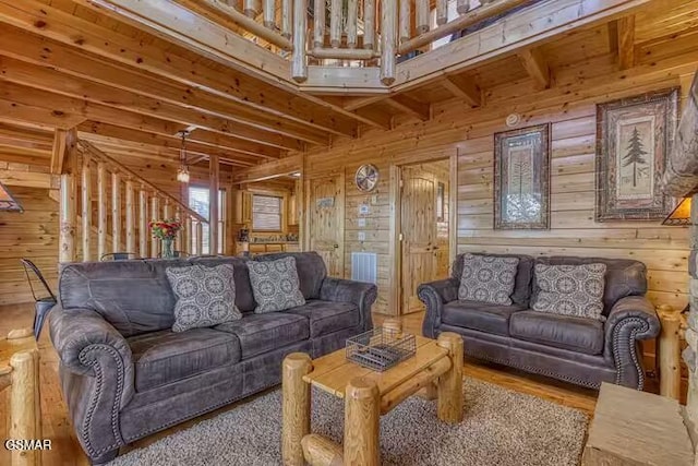 living room with wooden walls and hardwood / wood-style floors