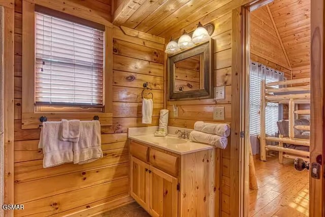 bathroom with vanity, wood walls, wood-type flooring, and wooden ceiling