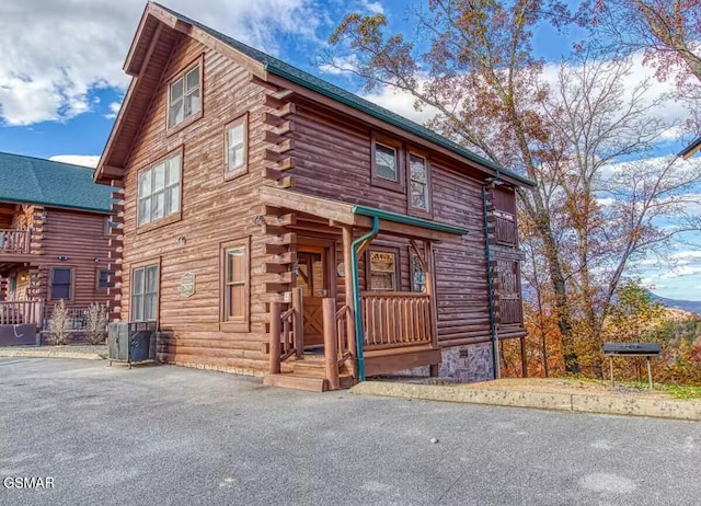 log cabin featuring central air condition unit