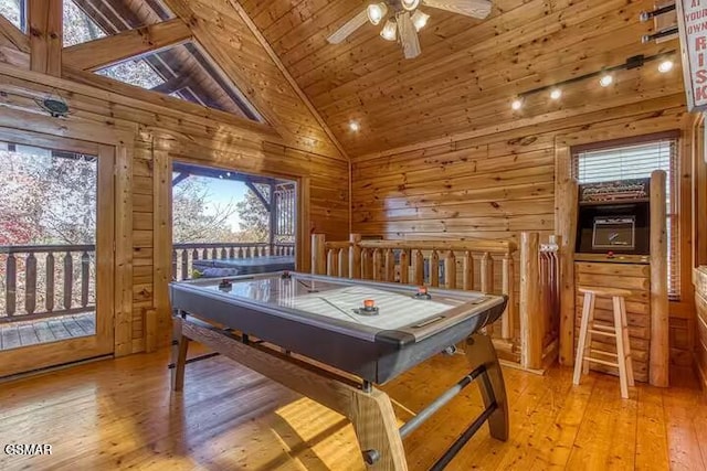 game room featuring wood walls, light hardwood / wood-style flooring, high vaulted ceiling, and wood ceiling