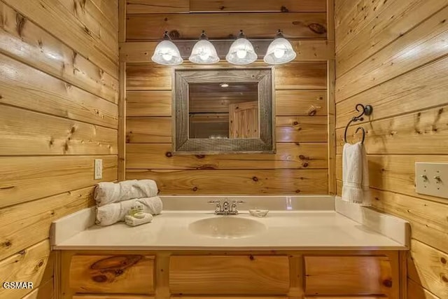 bathroom featuring vanity and wooden walls