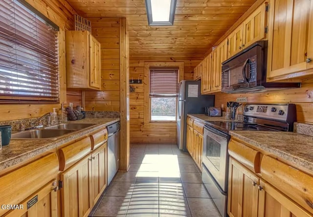 kitchen with wooden walls, dark tile patterned floors, wood ceiling, and appliances with stainless steel finishes