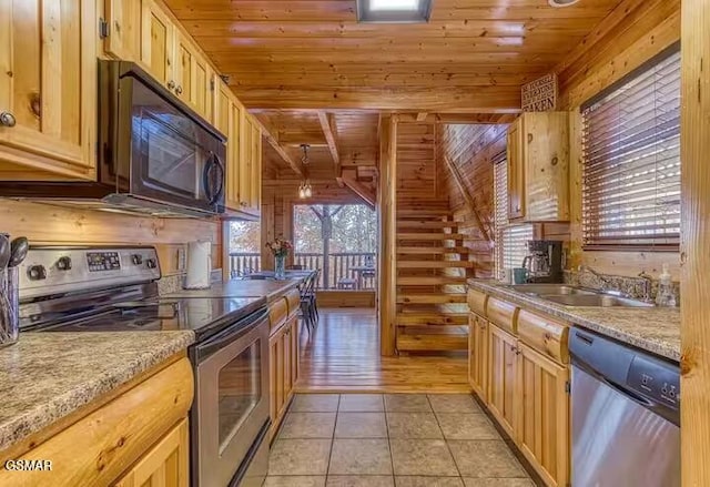 kitchen with sink, appliances with stainless steel finishes, light tile patterned flooring, light stone counters, and wood ceiling