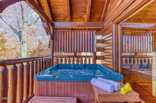 wooden deck with a hot tub