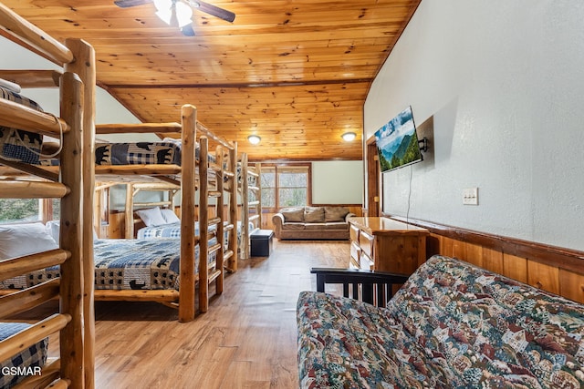 bedroom with light hardwood / wood-style floors, ceiling fan, wooden ceiling, and vaulted ceiling