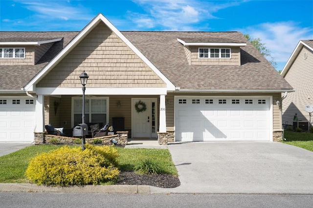 craftsman-style house featuring a porch and a garage